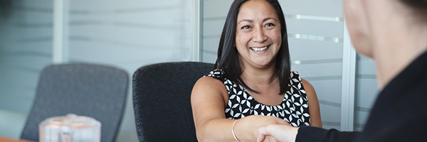 Two people shaking hands in an office