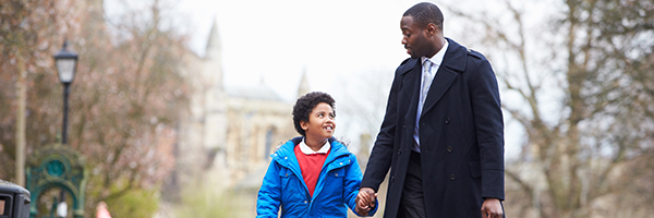 Man and child walking holding hands